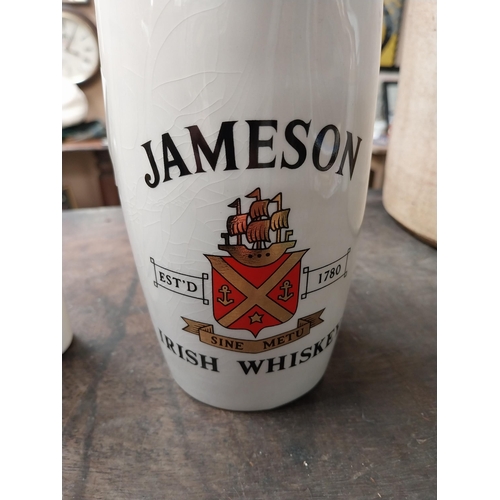 340 - Two Jameson Irish Whiskey ceramic water jugs. {18 cm H x 16 cm W x 10 cm D} and {16 cm H x 11 cm W x... 