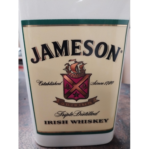 340 - Two Jameson Irish Whiskey ceramic water jugs. {18 cm H x 16 cm W x 10 cm D} and {16 cm H x 11 cm W x... 