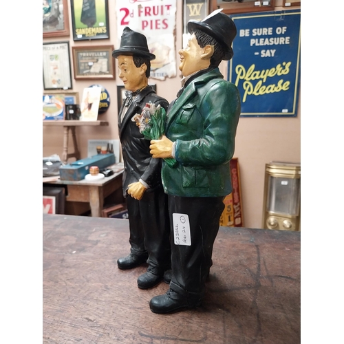 342 - Resin figure of Laurel and Hardy. {25 cm H x 21 cm W}.