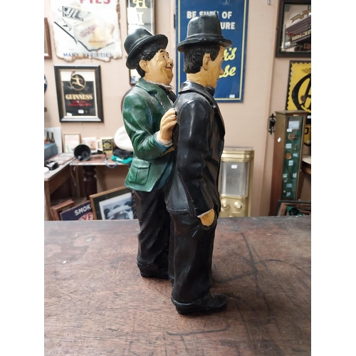 342 - Resin figure of Laurel and Hardy. {25 cm H x 21 cm W}.