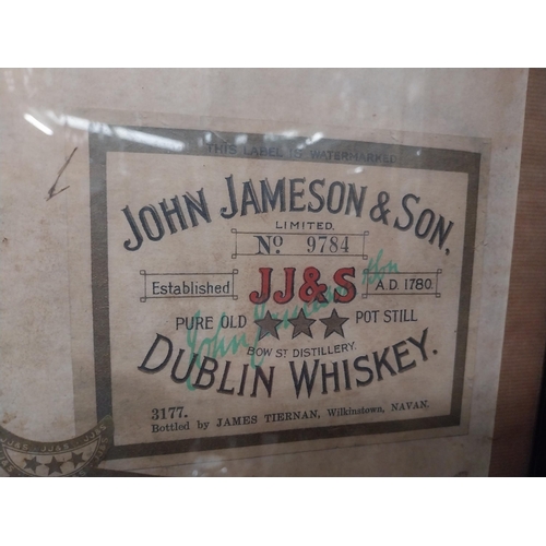 35 - Framed collection of three John Jameson and John Powers Whiskey labels. {44 cm H x 35 cm W}.