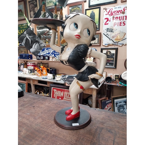 351 - Betty Boop advertising figure on stand with Underberg bottles. {73 cm H x 50 cm W}.