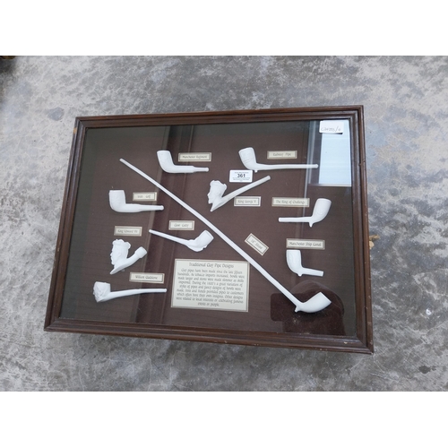 361 - Collection of Irish clay pipes in wooden and glazed display case. {29 cm H x 51 cm W x 8 cm D}.