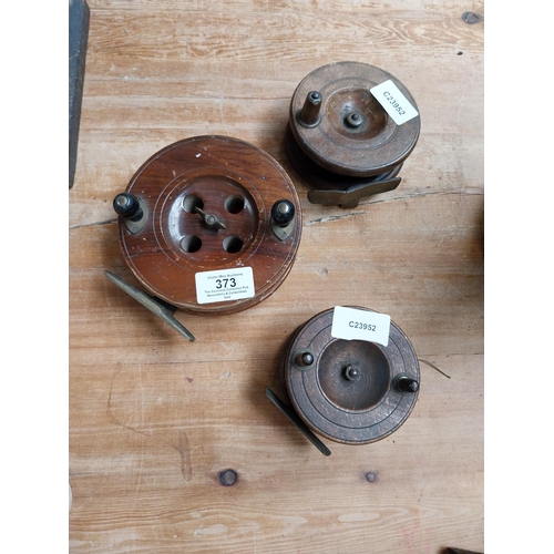 373 - Three 19th C. mahogany and brass fishing reels. {4 cm H x 13 cm Dia to 5 cm H x 5 cm Dia}.