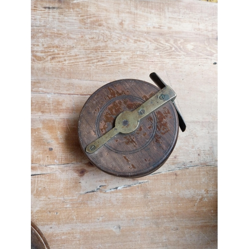 373 - Three 19th C. mahogany and brass fishing reels. {4 cm H x 13 cm Dia to 5 cm H x 5 cm Dia}.