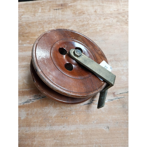 373 - Three 19th C. mahogany and brass fishing reels. {4 cm H x 13 cm Dia to 5 cm H x 5 cm Dia}.