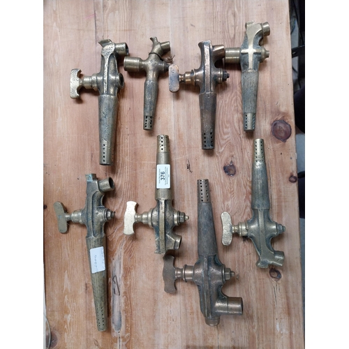 376 - Collection of eight early 20th C. brass barrel taps. {22 cm H x 14 cm W to 14 cm H x 7 cm W}.