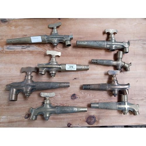 376 - Collection of eight early 20th C. brass barrel taps. {22 cm H x 14 cm W to 14 cm H x 7 cm W}.