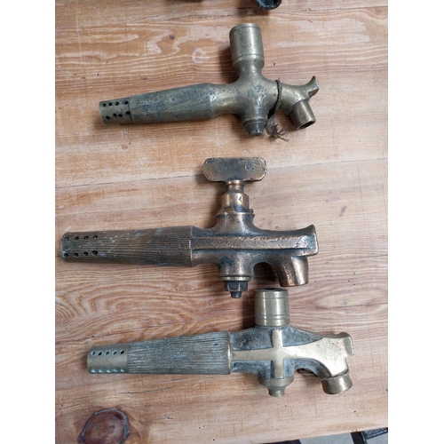 376 - Collection of eight early 20th C. brass barrel taps. {22 cm H x 14 cm W to 14 cm H x 7 cm W}.