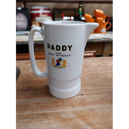 377 - Paddy Old Irish Whiskey Wade ceramic water jug {16 cm H x 14 cm W x 8 cm D} and a smaller one {12 cm... 