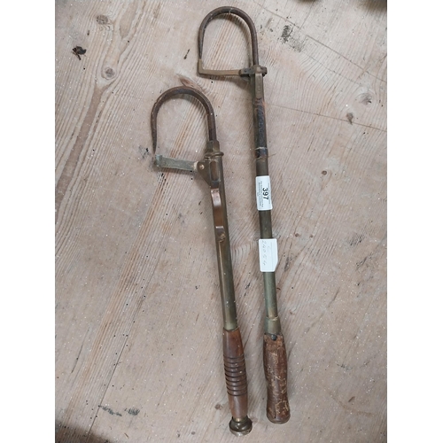 397 - Two early 20th C. brass and metal fishing gaffs. {47 cm H x 8 cm W}.