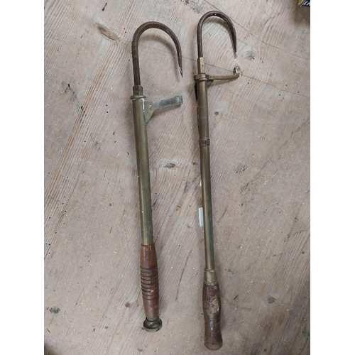 397 - Two early 20th C. brass and metal fishing gaffs. {47 cm H x 8 cm W}.