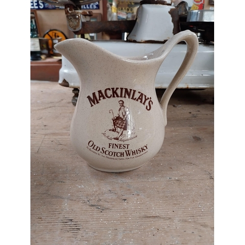 400 - Johnnie Walker {13 cm H x 15 cm W x 12 cm D} advertising jug and Mackinlay jug {16 cm H x 16 cm W x ... 