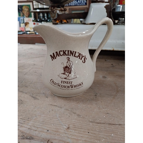 400 - Johnnie Walker {13 cm H x 15 cm W x 12 cm D} advertising jug and Mackinlay jug {16 cm H x 16 cm W x ... 