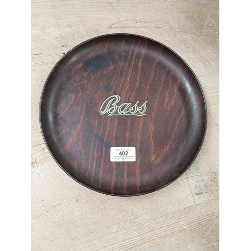 402 - Two Bass drinks trays - one wooden one tinplate. {25 cm Dia. and 21 cm Dia.}