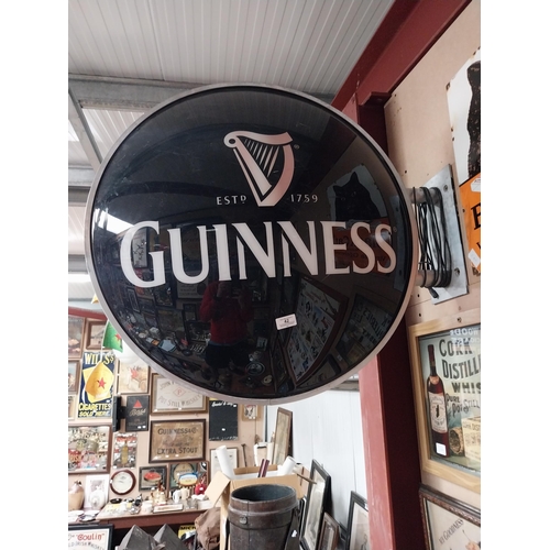 42 - Guinness Perspex double sided light up advertising sign with bracket. {64 cm Dia.}