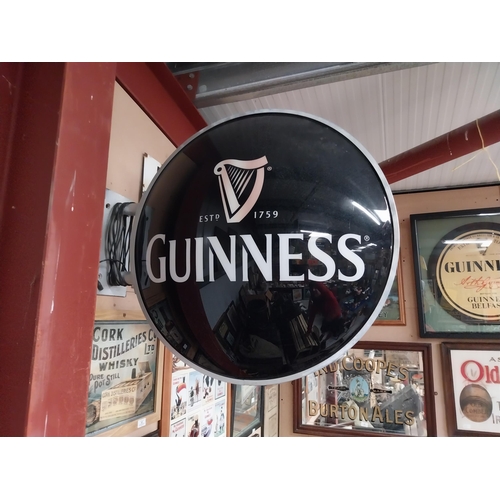 42 - Guinness Perspex double sided light up advertising sign with bracket. {64 cm Dia.}