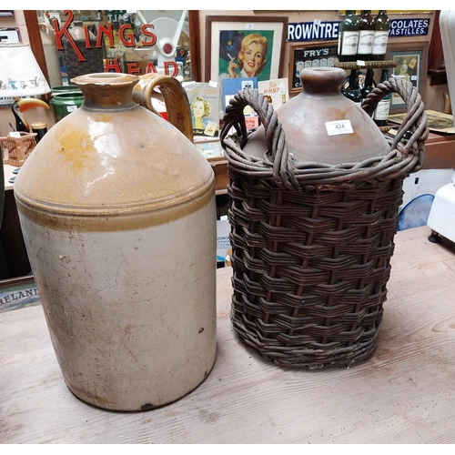 424 - 19th C. Stoneware whiskey flagon in original basket {45cm H x 30 cm Dia.} and another without basket... 