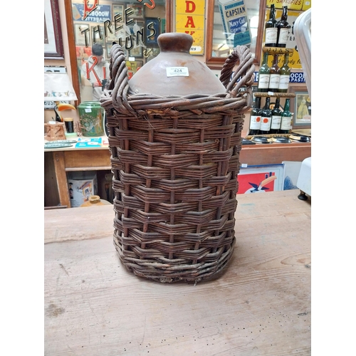 424 - 19th C. Stoneware whiskey flagon in original basket {45cm H x 30 cm Dia.} and another without basket... 