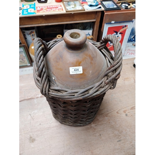 424 - 19th C. Stoneware whiskey flagon in original basket {45cm H x 30 cm Dia.} and another without basket... 