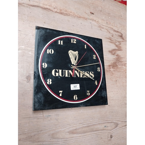 427 - 1970's Perspex Guinness battery advertising clock. {30 cm H x 30 cm W}.