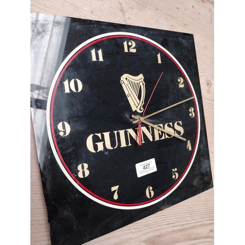 427 - 1970's Perspex Guinness battery advertising clock. {30 cm H x 30 cm W}.