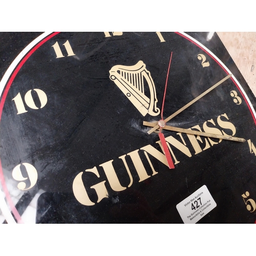 427 - 1970's Perspex Guinness battery advertising clock. {30 cm H x 30 cm W}.