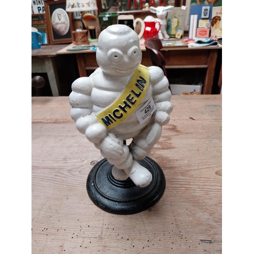 429 - Cast iron Michelin Man on stand. {29 cm H x 14 cm Dia.}.