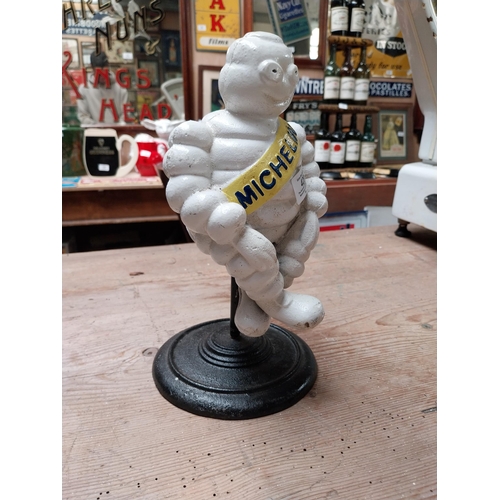 429 - Cast iron Michelin Man on stand. {29 cm H x 14 cm Dia.}.