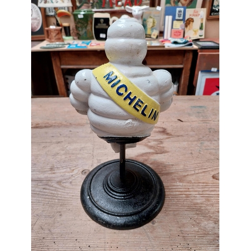 429 - Cast iron Michelin Man on stand. {29 cm H x 14 cm Dia.}.