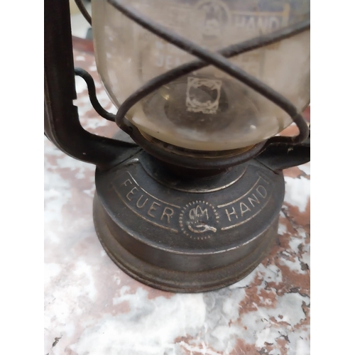 457 - Brass and metal Tilly lamp and two Hurricane lamps. {33 cm H x 16 cm Dia. and 25 cm H x 14 cm Dia.}.