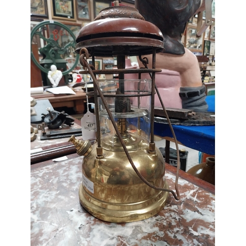 457 - Brass and metal Tilly lamp and two Hurricane lamps. {33 cm H x 16 cm Dia. and 25 cm H x 14 cm Dia.}.