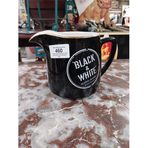 460 - Black and White Whiskey water jug. {11 cm H x 17 cm W x 11 cm D}.