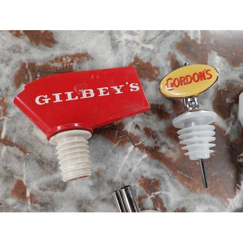 465 - Seven bottle pourers - Gordons, White Horse, Noilly, Gilbeys etc. {6 cm H x 3 cm W}. Approx