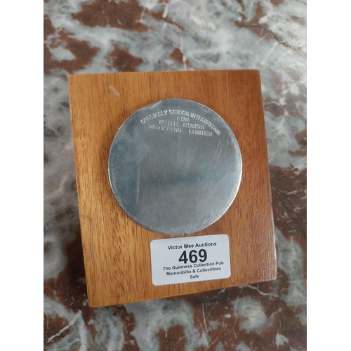 469 - Coin specially struck in Great Britain for White Horse Distillers Ltd mounted on wooden presentation... 