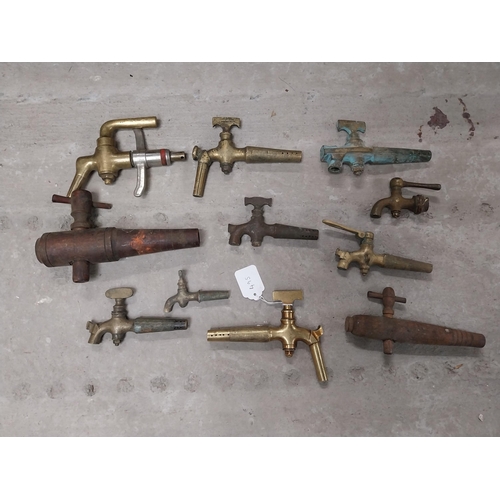 495 - Collection of nine 19th C. brass barrel taps and two wooden barrel taps.