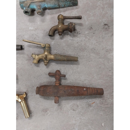 495 - Collection of nine 19th C. brass barrel taps and two wooden barrel taps.