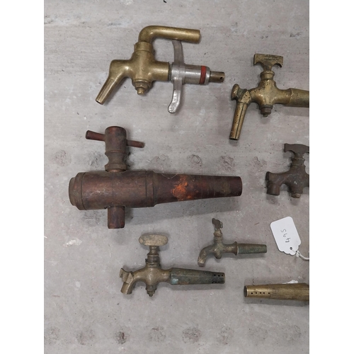 495 - Collection of nine 19th C. brass barrel taps and two wooden barrel taps.