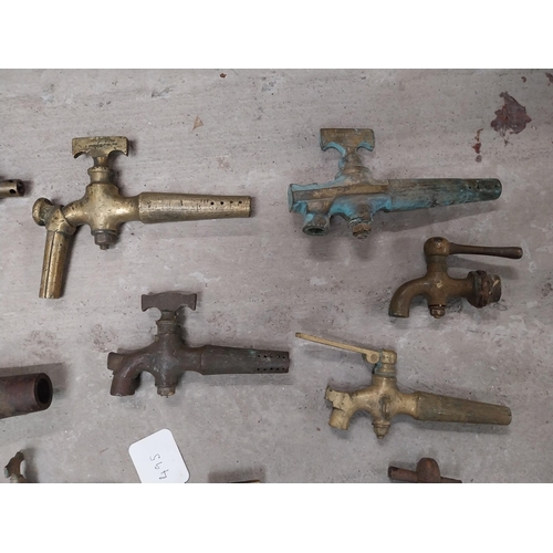 495 - Collection of nine 19th C. brass barrel taps and two wooden barrel taps.