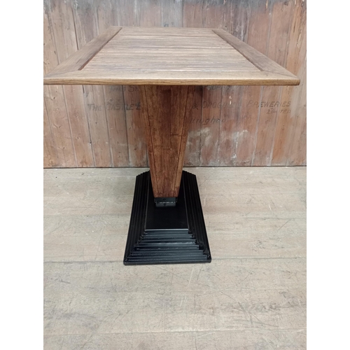 500 - Cast iron stepped drink stand high table with Iroka top and four iron high stools with leather seats... 