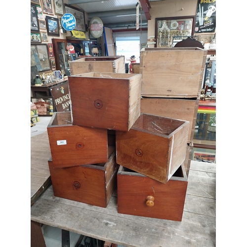 562 - Collection of eleven mahogany graduated set of shop drawers.