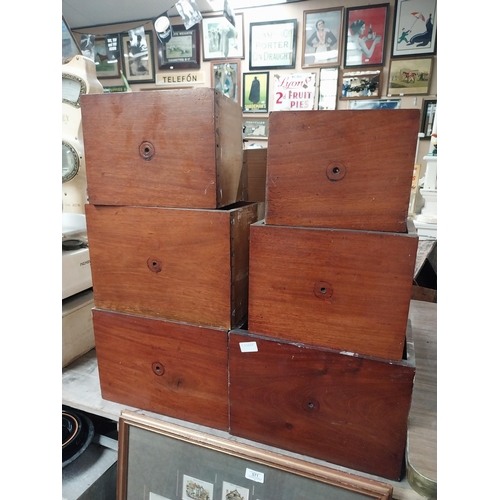 562 - Collection of eleven mahogany graduated set of shop drawers.