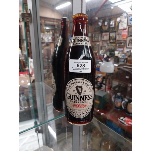 628 - Three sliced Guinness display bottles. {20 cm H} approx. PART OF THE DAVID HUGHES COLLECTION.