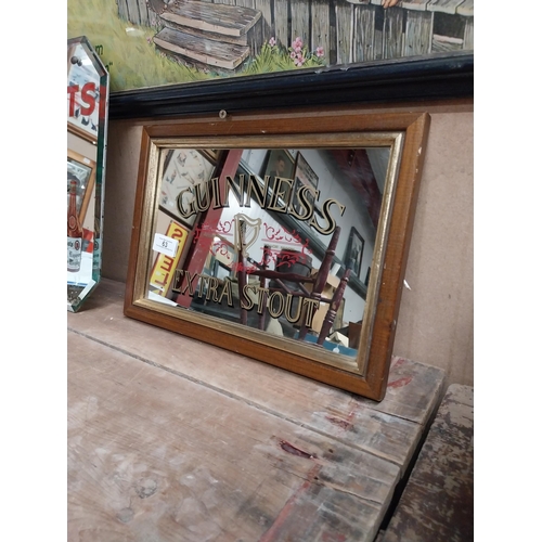 63 - Framed 1970's Guinness Extra Stout advertising mirror. {24 cm H x 34 cm W}.