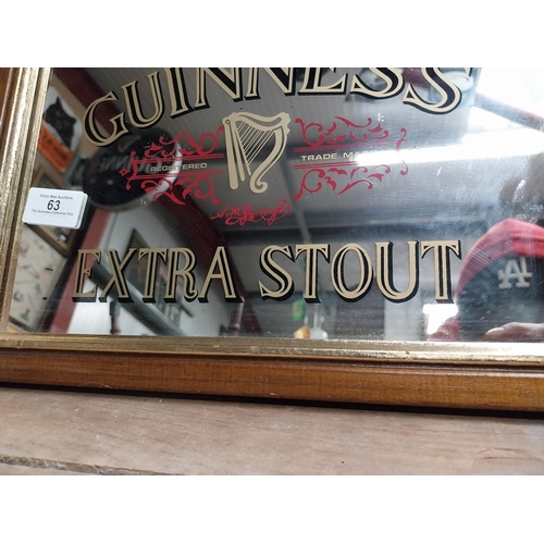 63 - Framed 1970's Guinness Extra Stout advertising mirror. {24 cm H x 34 cm W}.