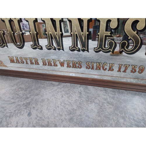 666 - 20th C. Guinness Master Brewers since 1759 framed advertising mirror {86 cm H x 167 cm W}.