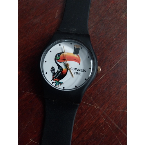 674 - Three Guinness plastic watches: Descending pint glasses, Toucan, black watch face with red/cream str... 