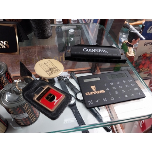 678 - Mixed items: Draught Guinness candle, bottle candle, menu holder, Guinness Harmonica, Guinness Paper... 