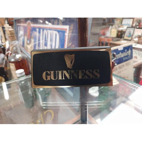 678 - Mixed items: Draught Guinness candle, bottle candle, menu holder, Guinness Harmonica, Guinness Paper... 