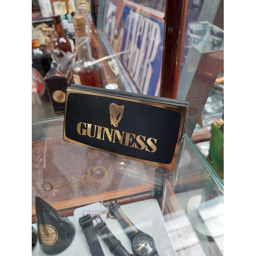 678 - Mixed items: Draught Guinness candle, bottle candle, menu holder, Guinness Harmonica, Guinness Paper... 